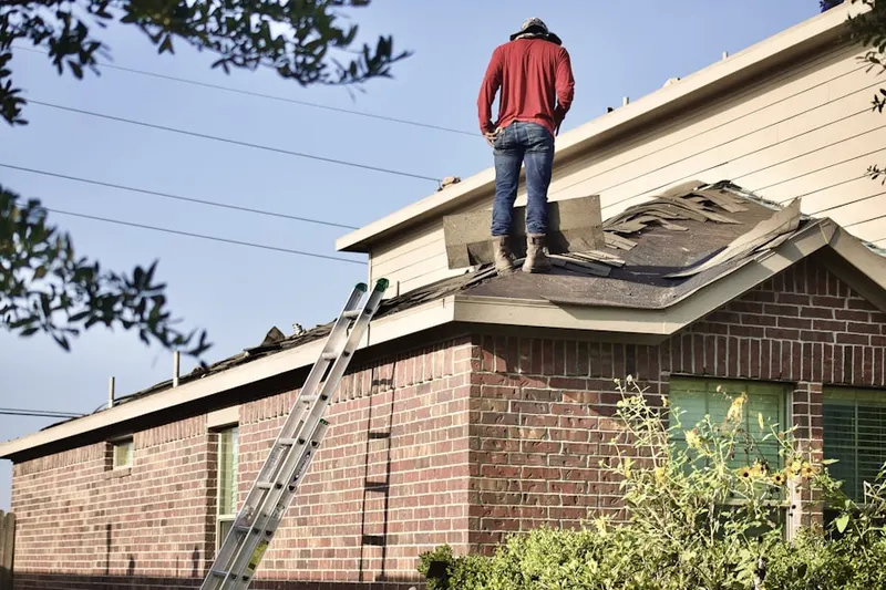 Professional roofer working on a residential roof in Alamance